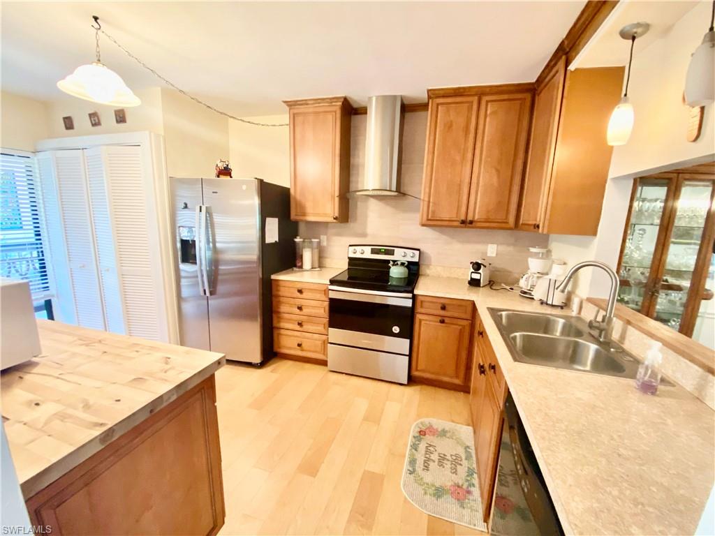 a kitchen with a refrigerator sink and stove