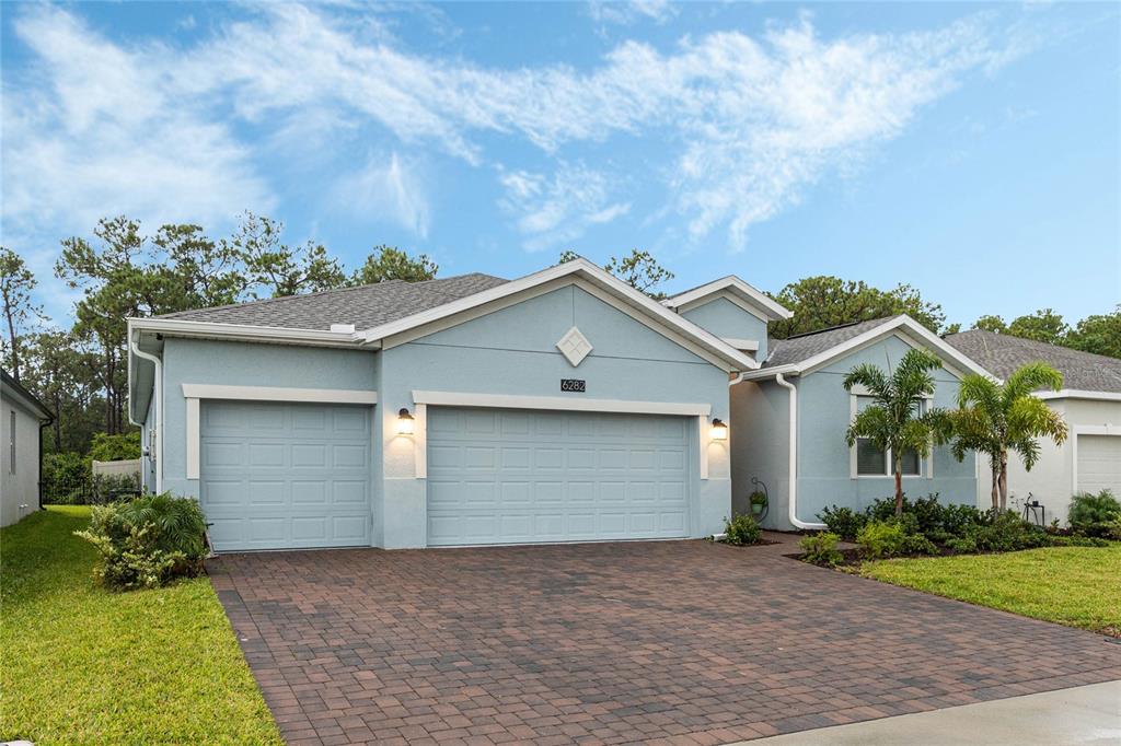 a view of a house with a yard and garage