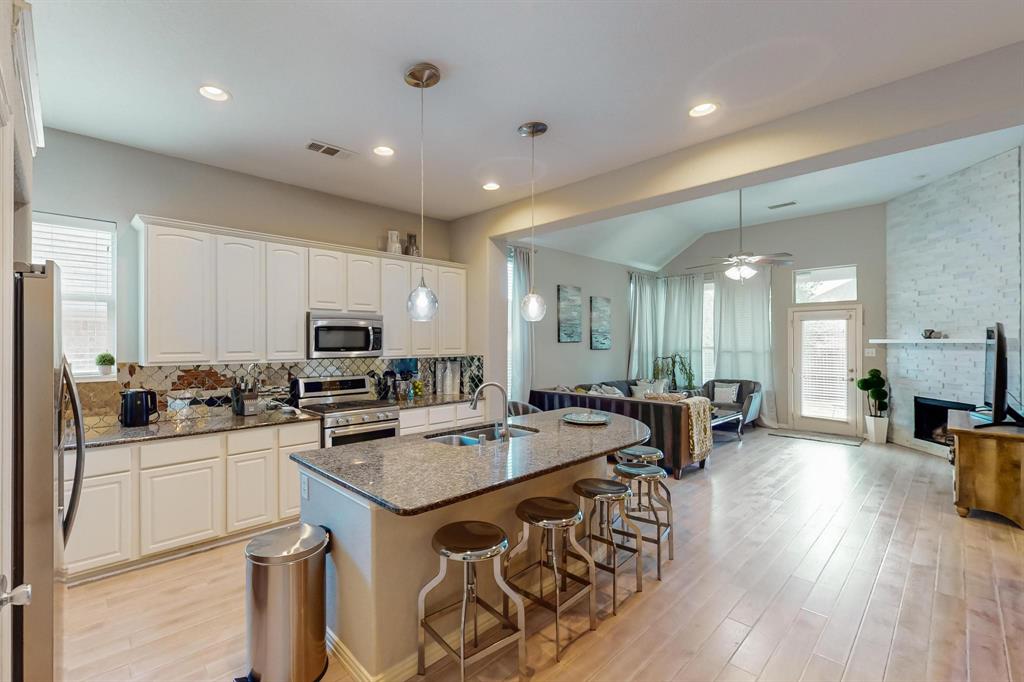 a kitchen with sink refrigerator and cabinets