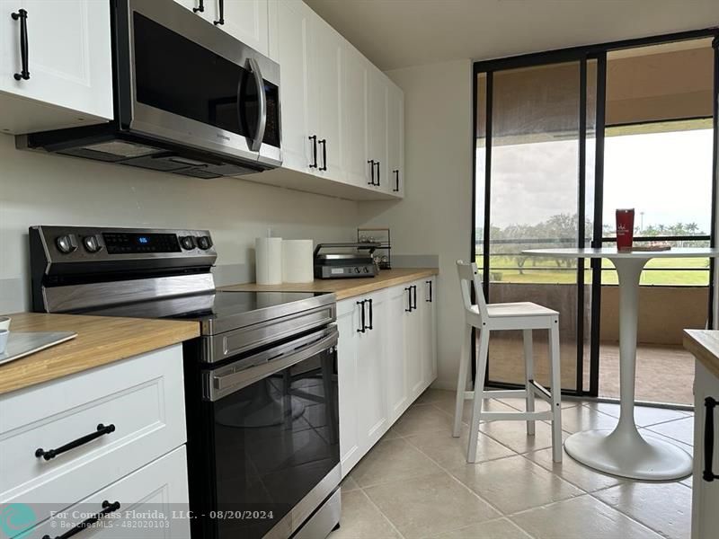 a kitchen with stainless steel appliances a stove a sink and a microwave