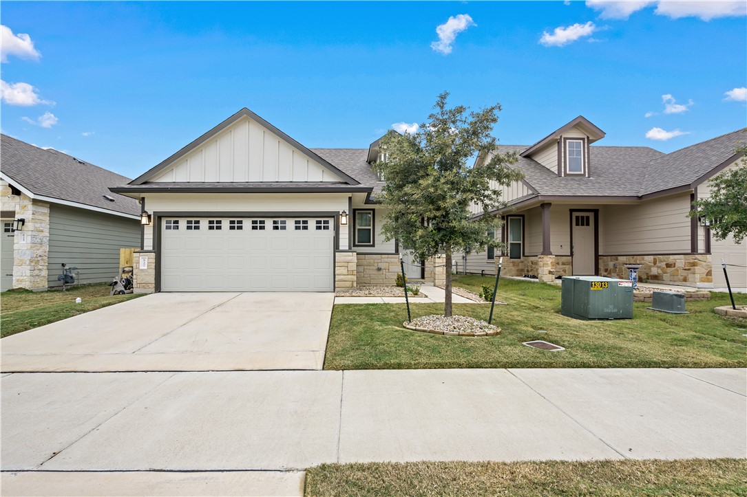 Craftsman house featuring central AC unit, a garag