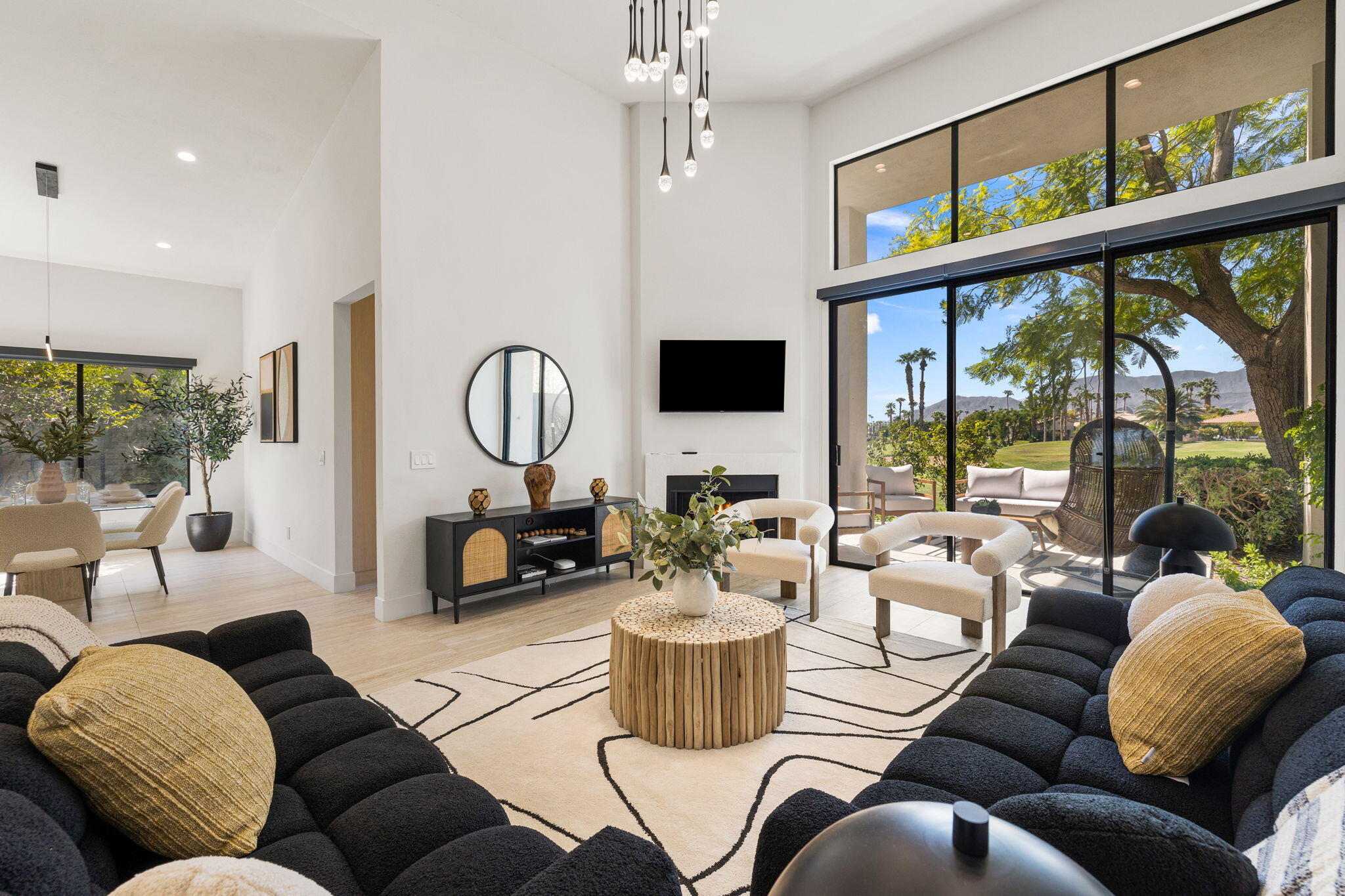 a living room with furniture fireplace and a large window