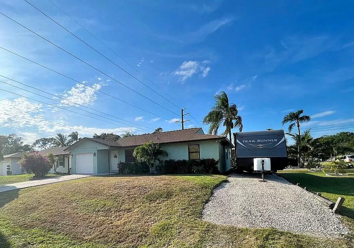 a front view of a house with a yard and a garage