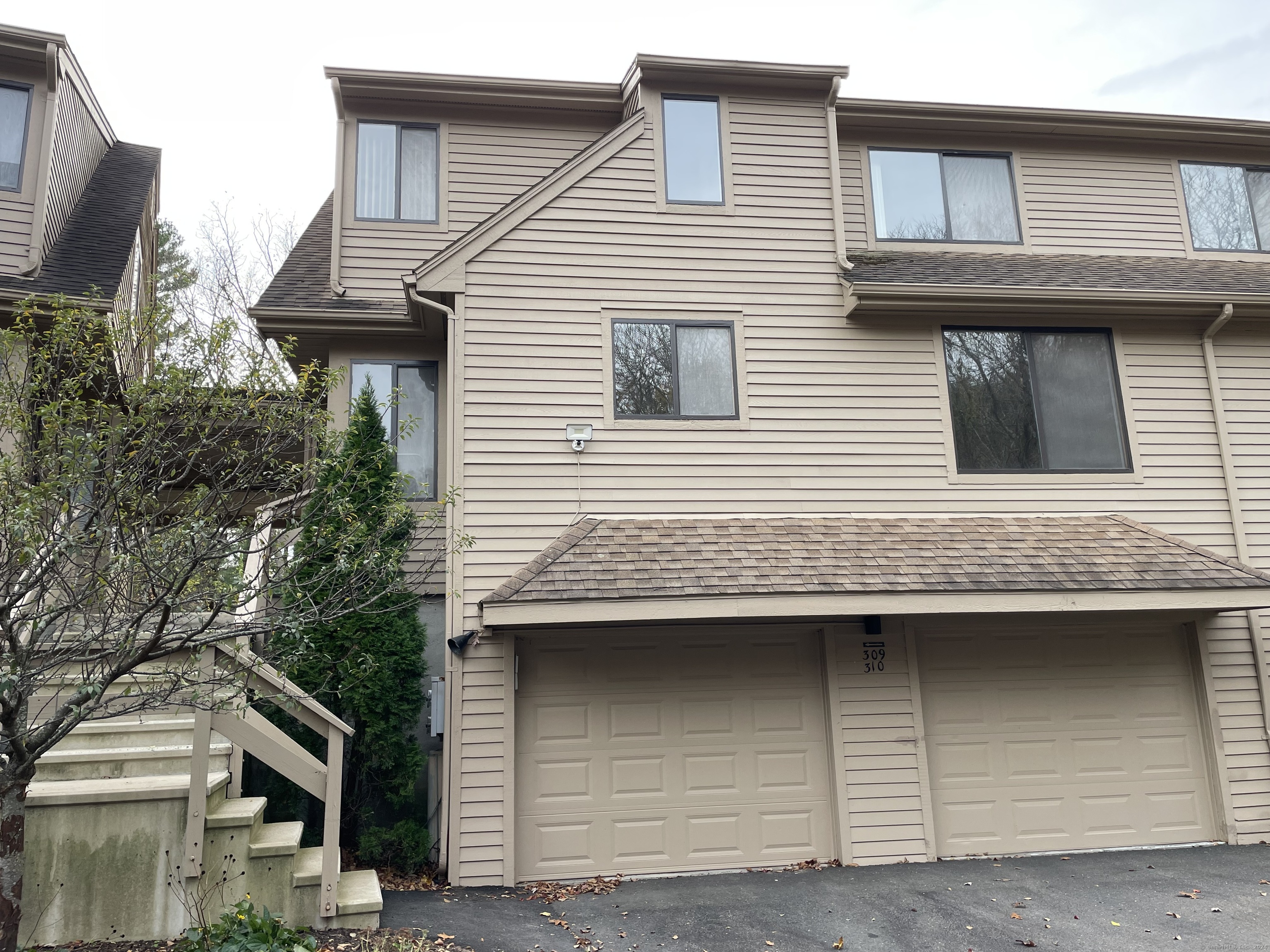 a view of a house with a garage and balcony