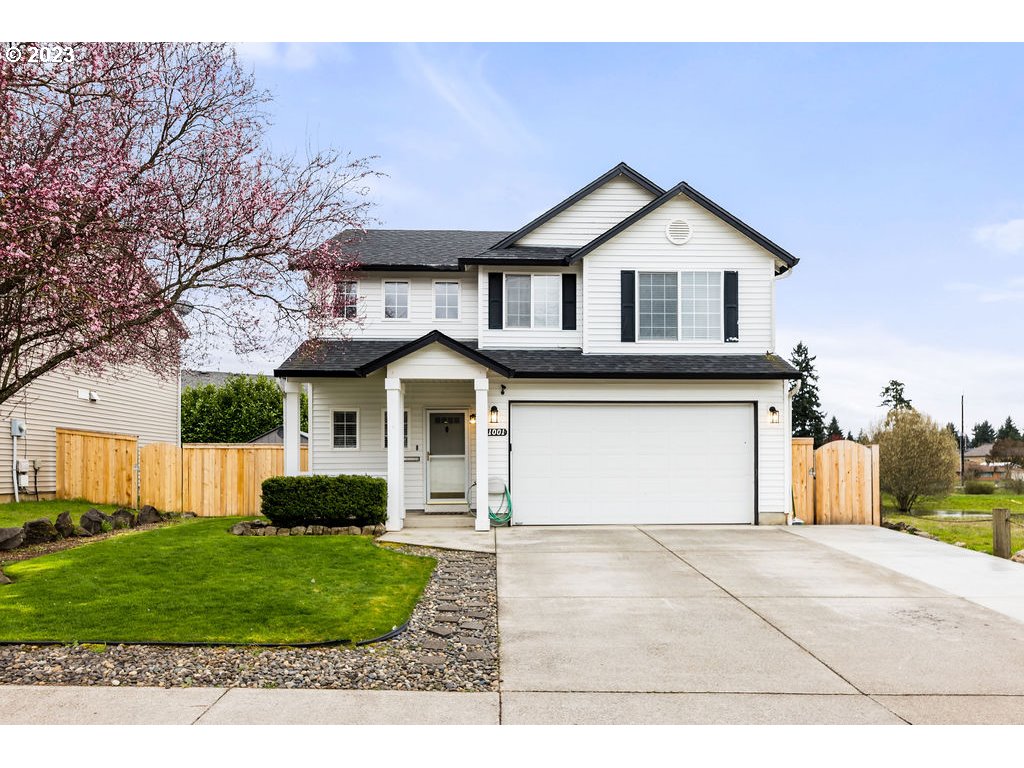 a front view of a house with a yard and garage