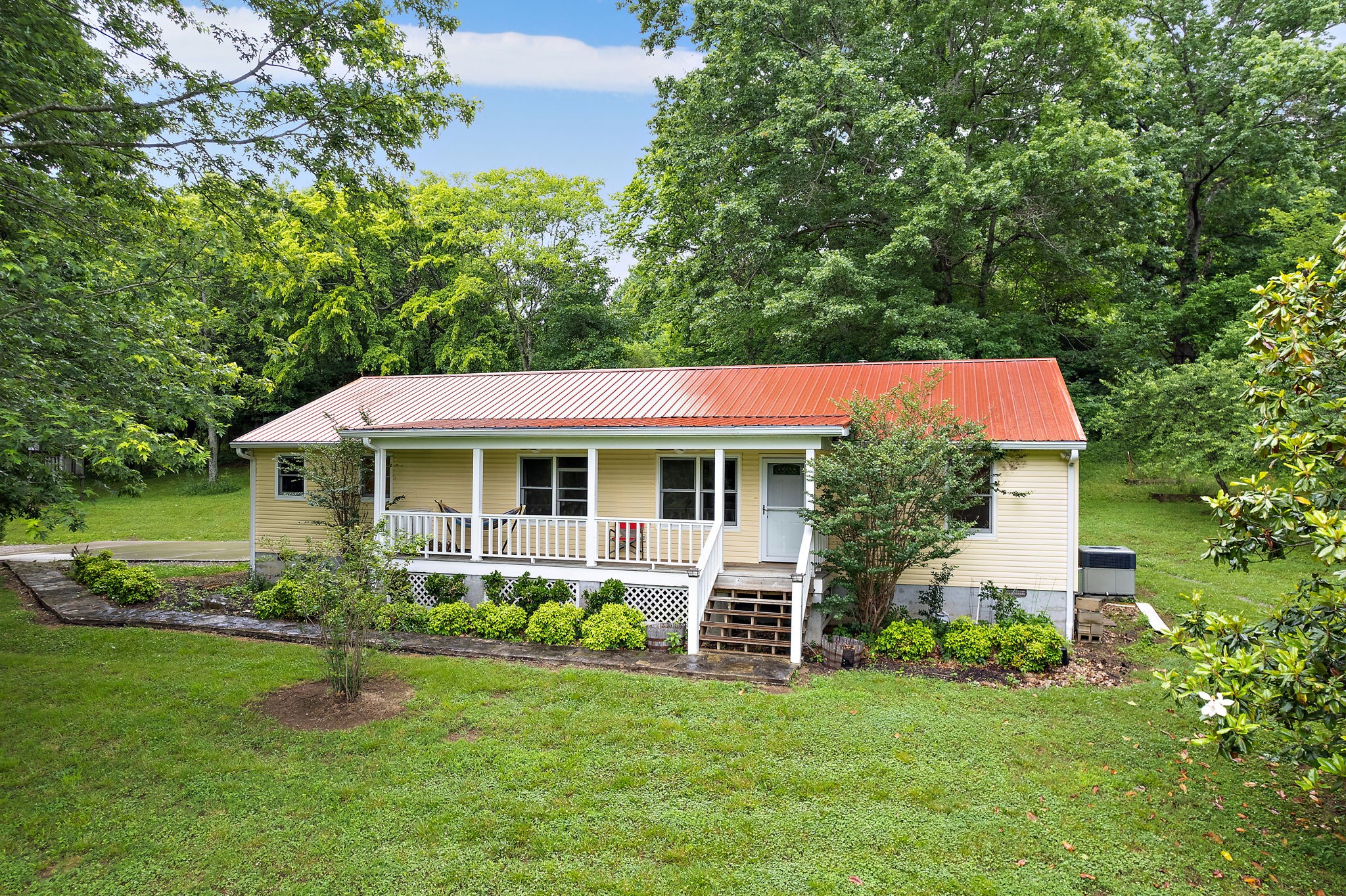 a front view of a house with a garden