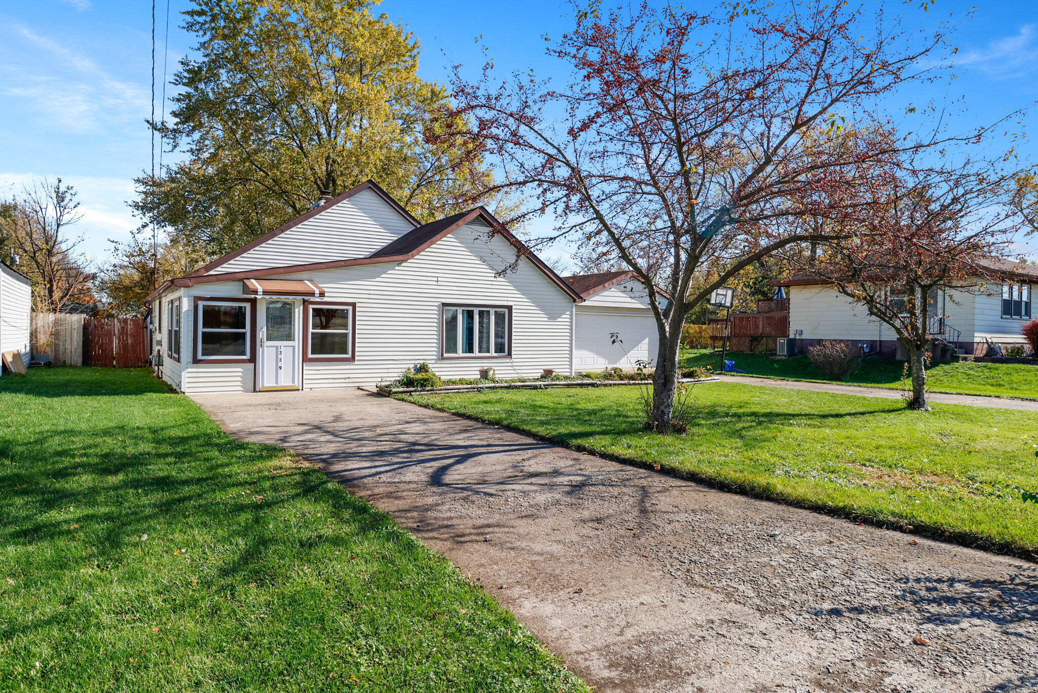 a front view of house with yard and green space