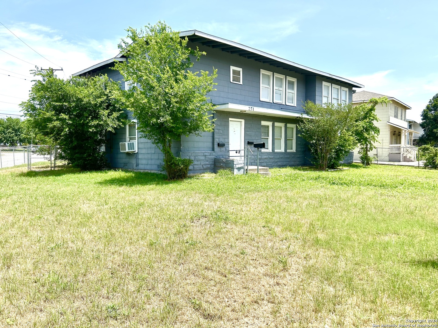 a view of a house with a yard and sitting area