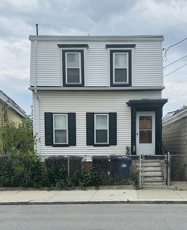 a house that has a tree in front of it