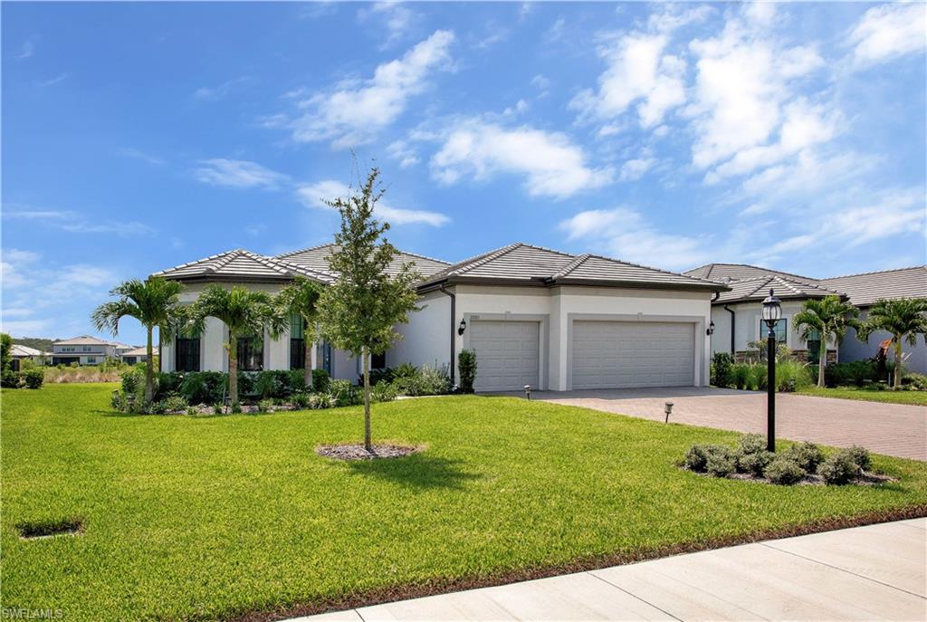 View of front of home featuring a garage and a front lawn