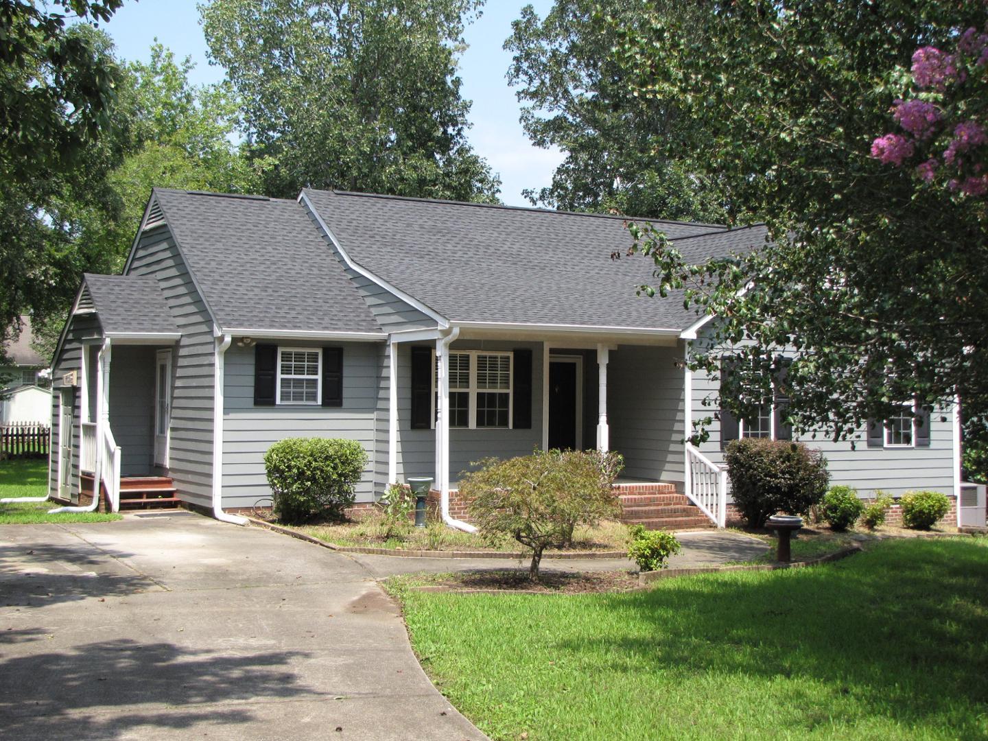 a front view of a house with a yard and porch