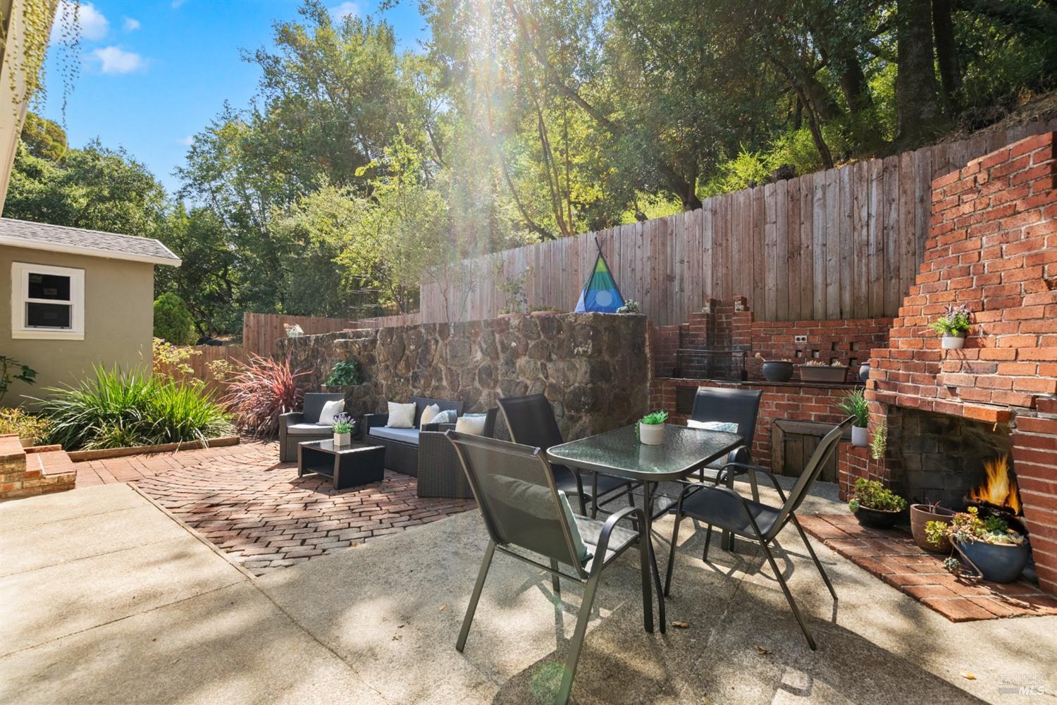 a backyard of a house with table and chairs