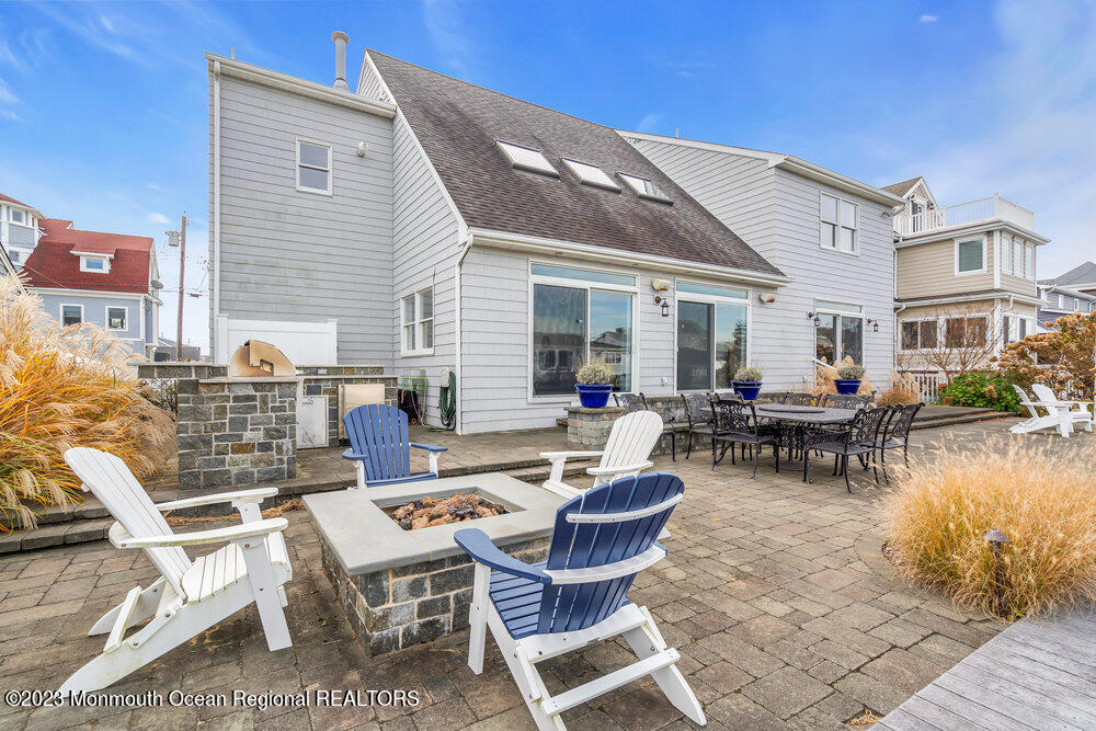 a view of a patio with dining table and chairs with wooden floor and fence