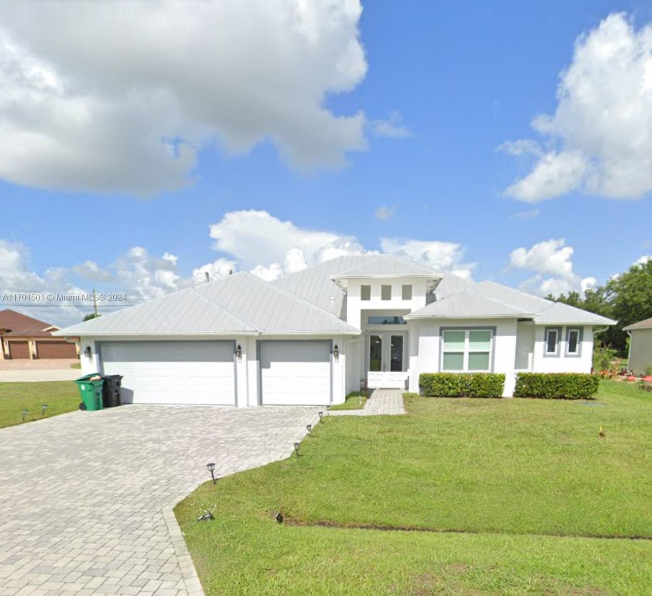 a front view of a house with a garden