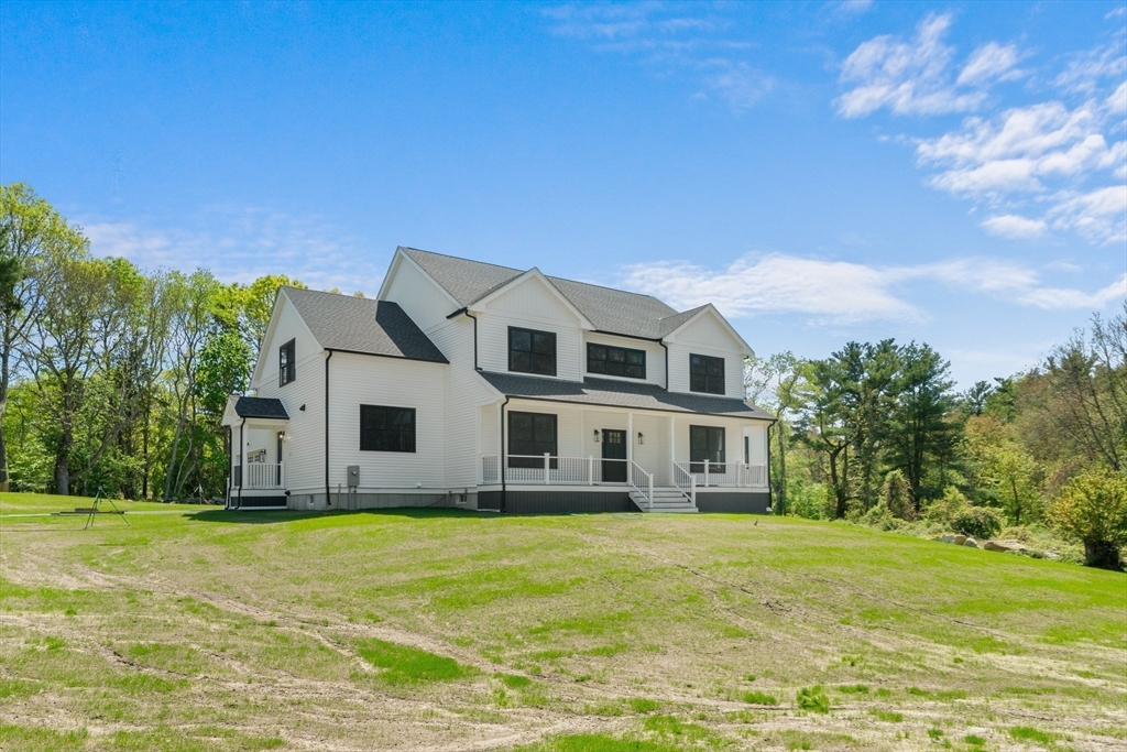 a house view with swimming pool in front of it