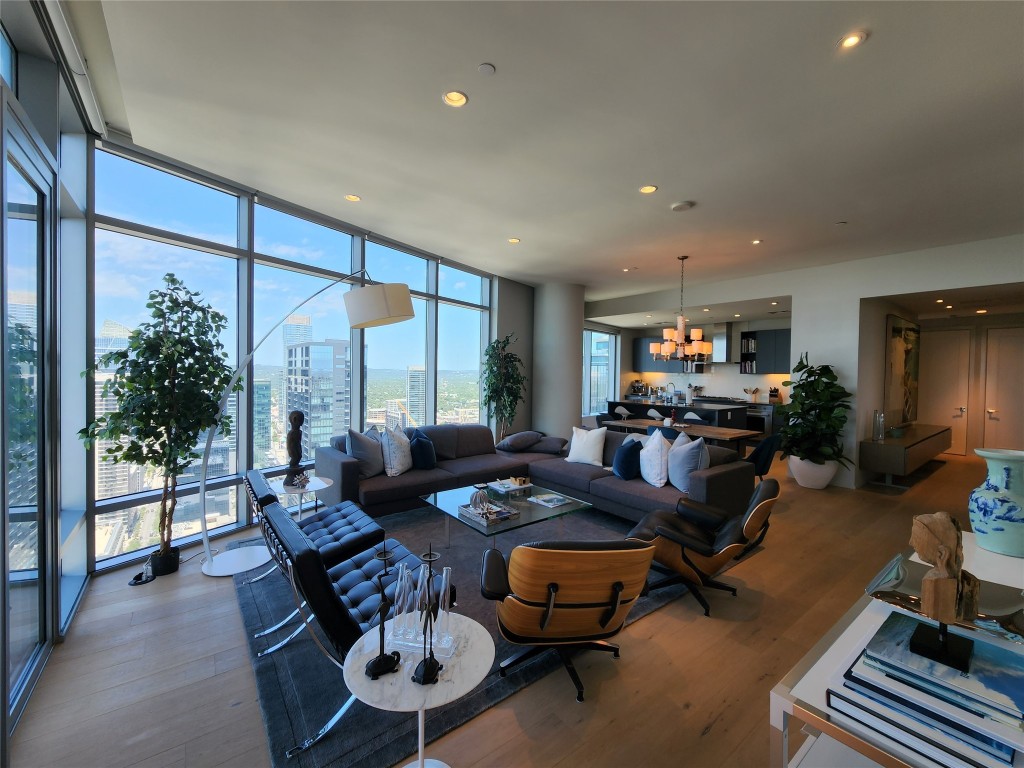 a living room with furniture a window and a flat screen tv