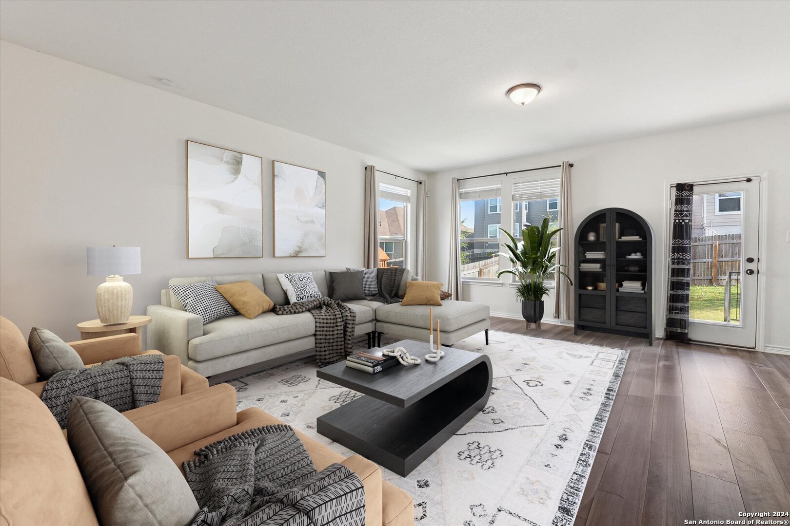 a living room with furniture and wooden floor