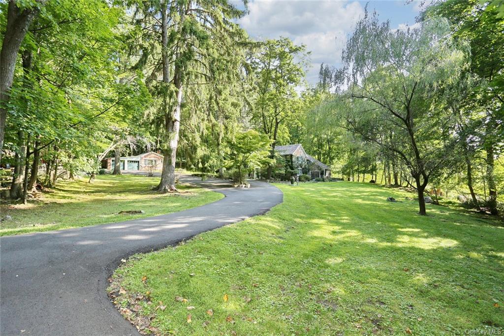 View of home's community with a lawn