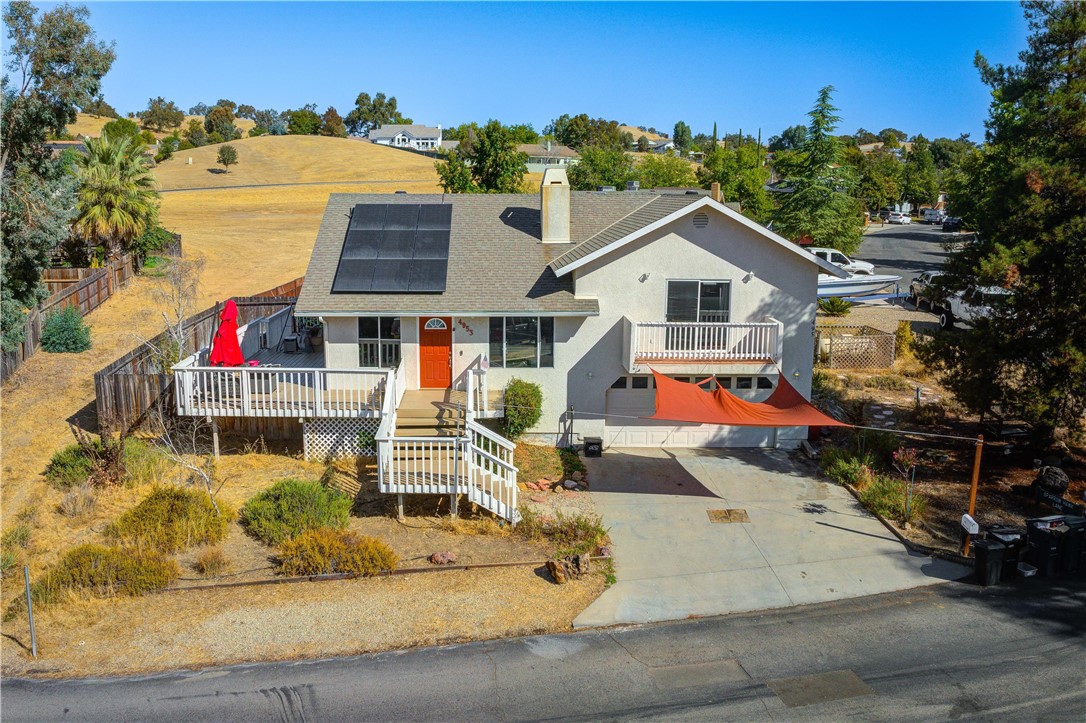 an aerial view of a house with a yard and potted plants