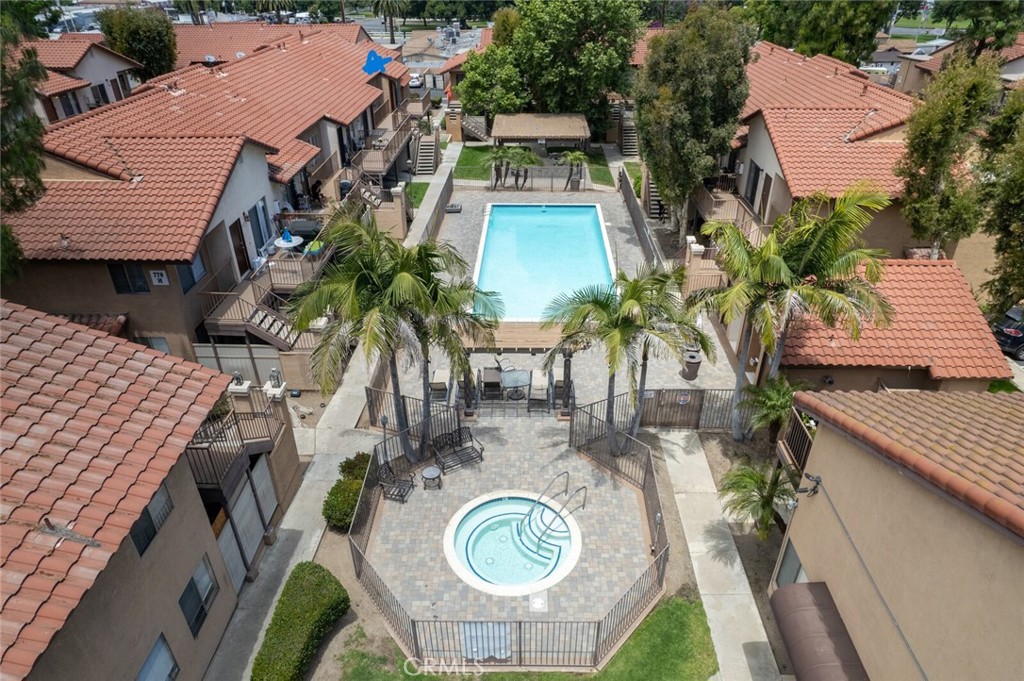 an aerial view of a house with outdoor space and trees all around