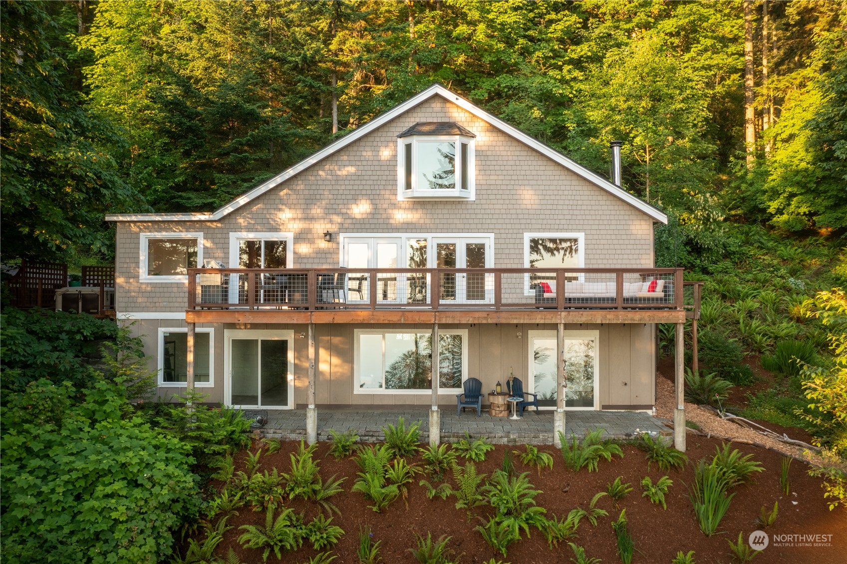 a front view of a house with swimming pool and glass windows