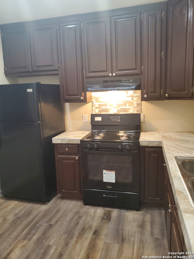 a stove top oven sitting inside of a kitchen