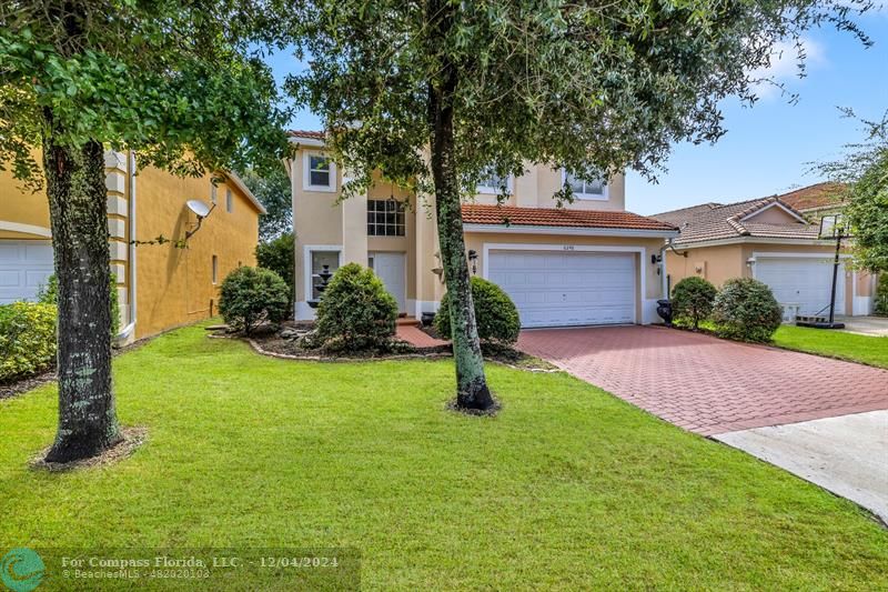 a view of a house with a yard and tree s