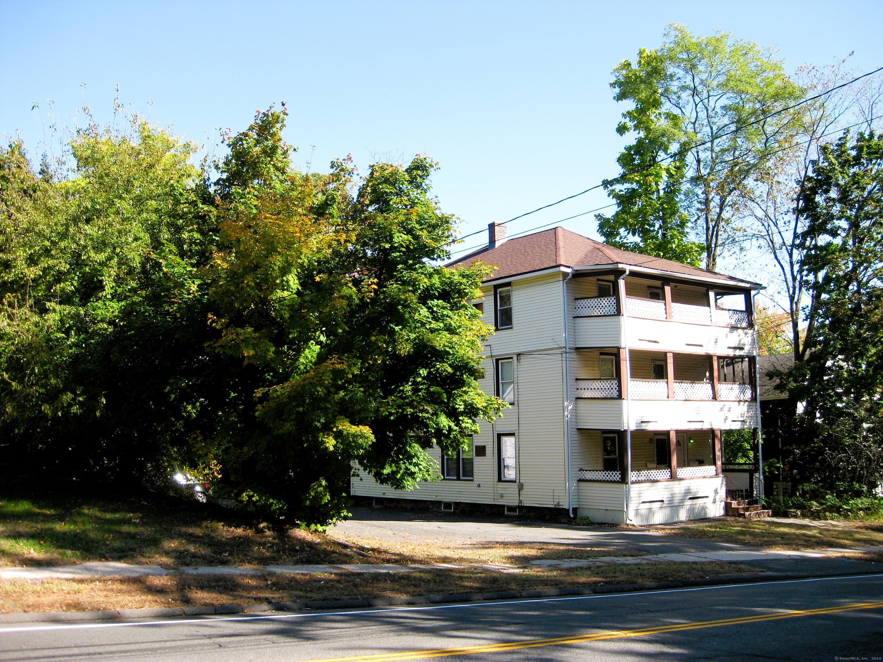 a view of a tall building next to a road