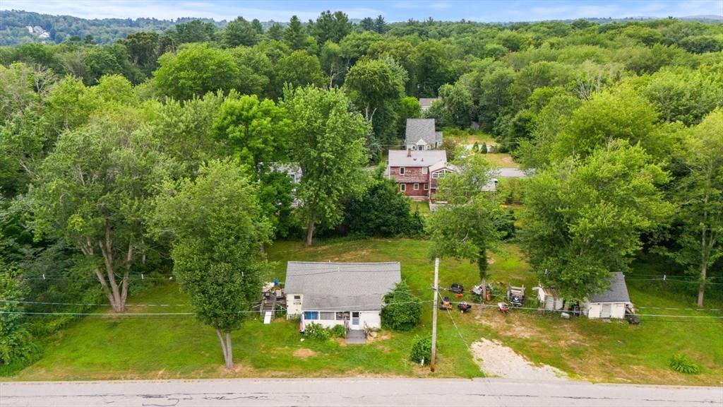 an aerial view of a house with a yard