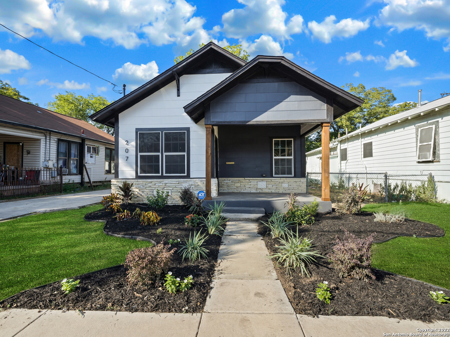 a front view of a house with garden