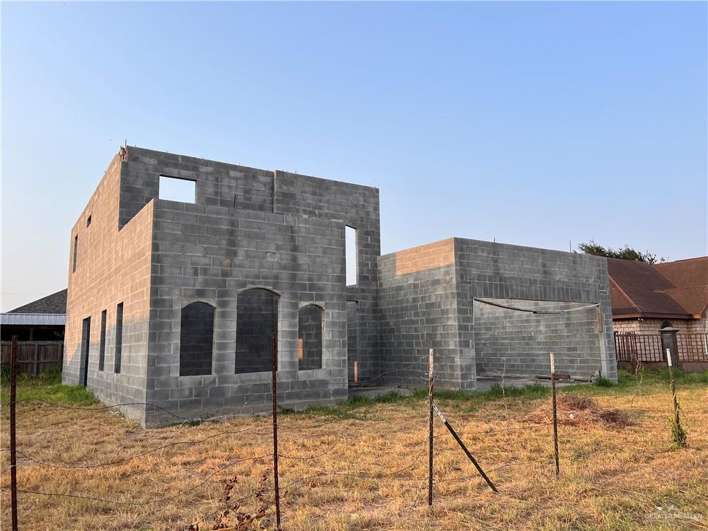 a brick building with a bench in front of it