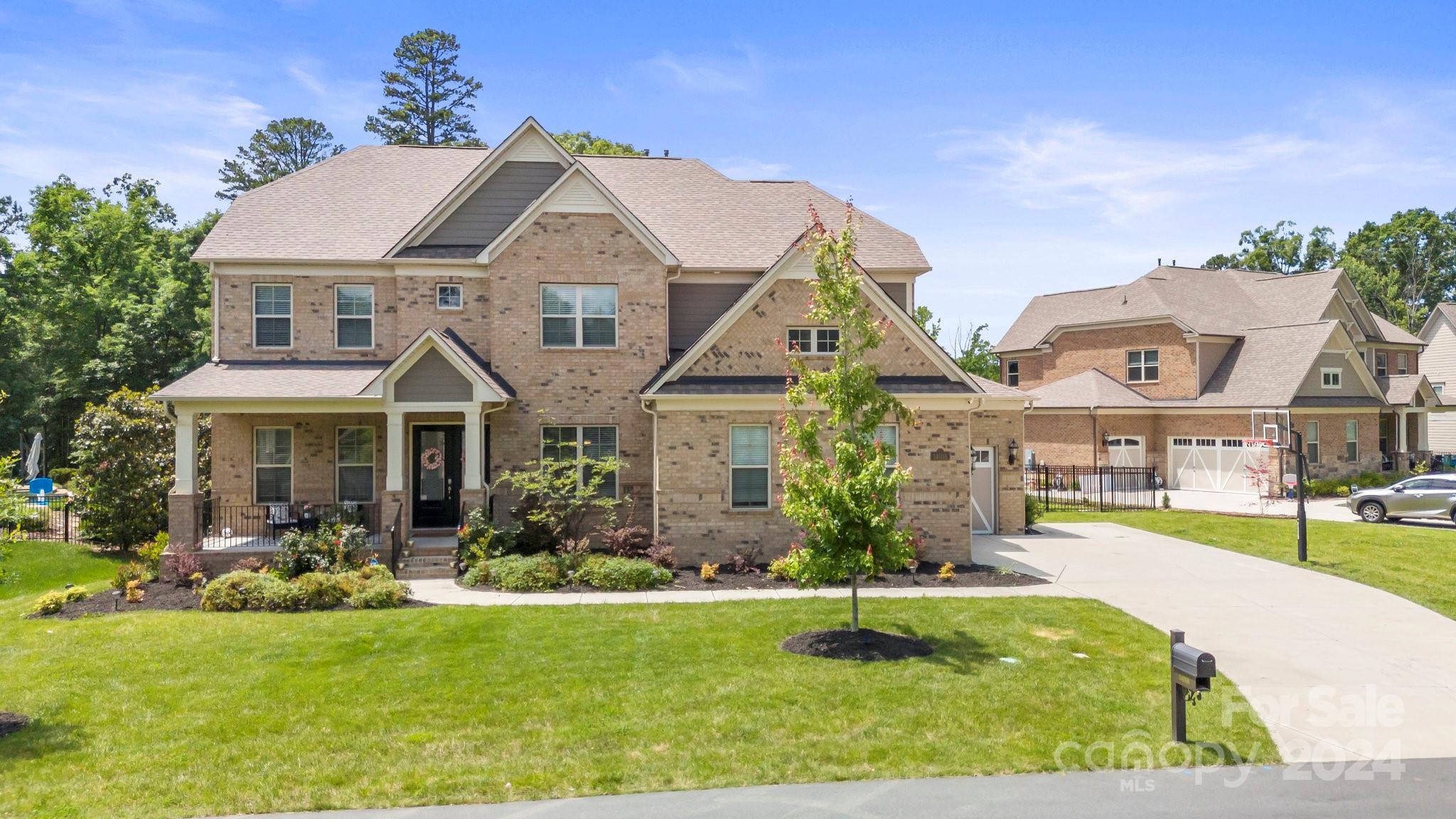 a front view of house with yard and green space