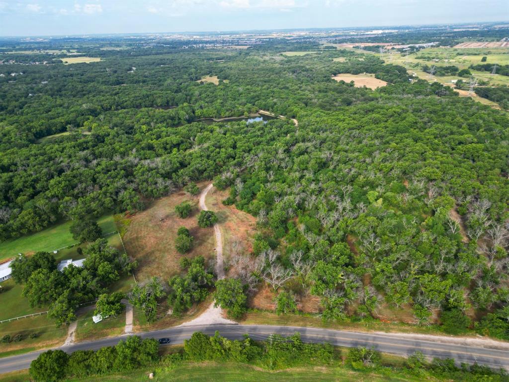 an aerial view of a houses with yard