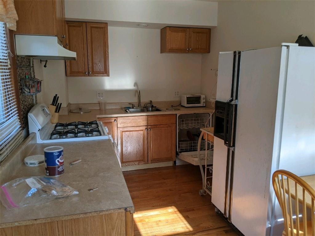 a kitchen with a refrigerator and a stove