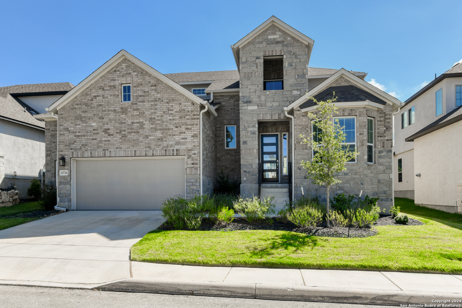 a front view of a house with a yard and garage