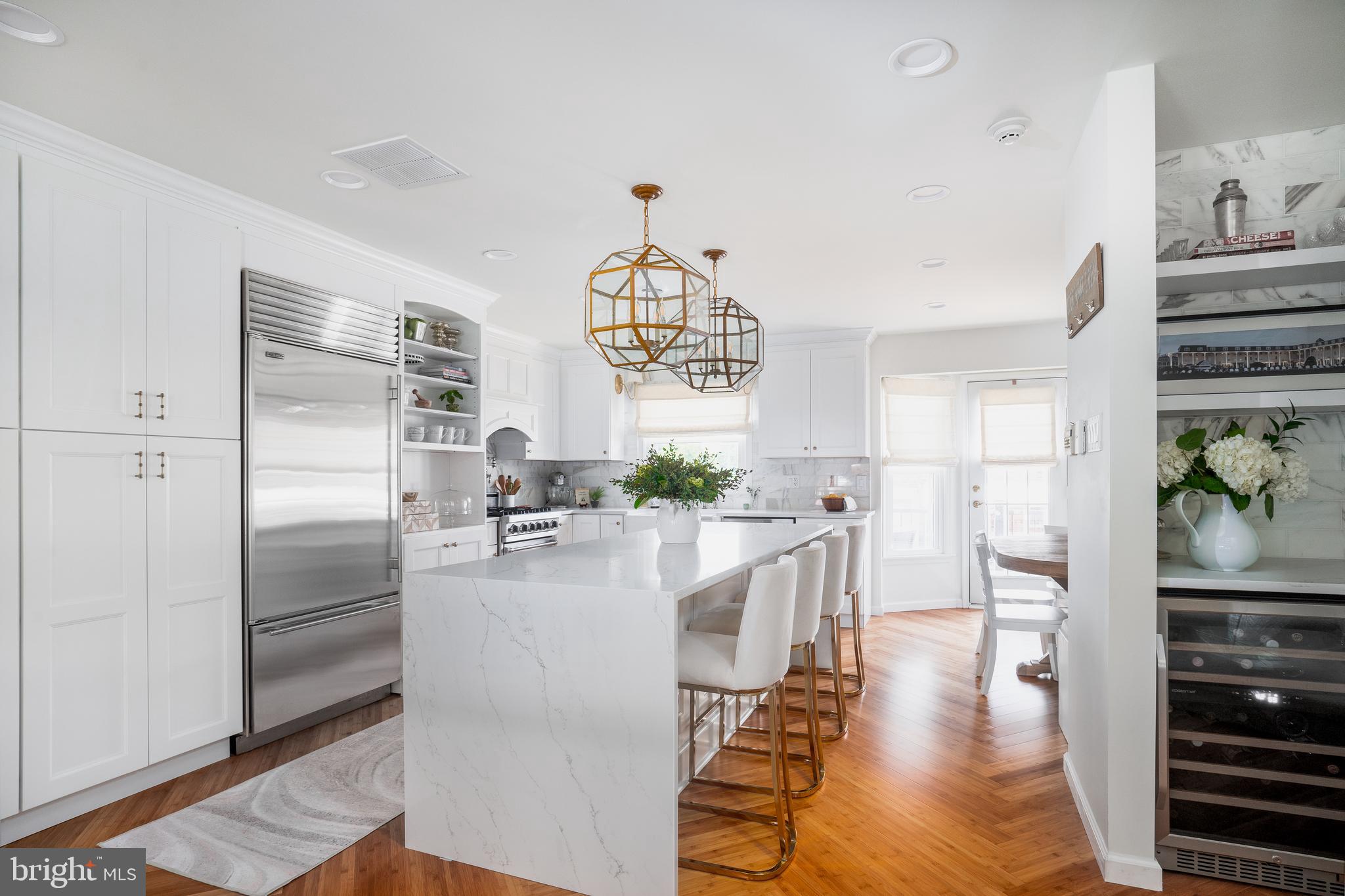 a kitchen with kitchen island a counter top space stainless steel appliances and cabinets