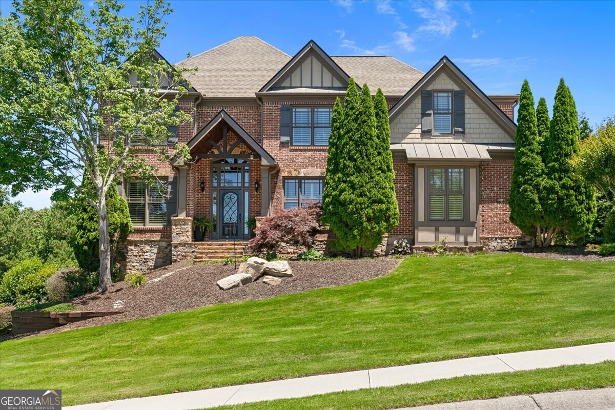 a front view of a house with a yard and garage