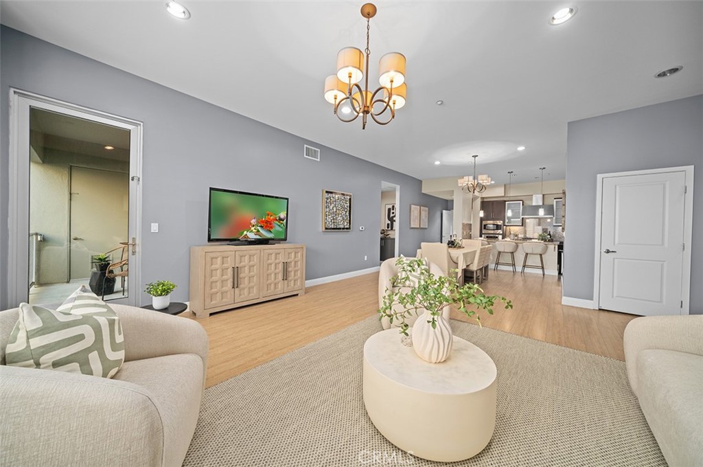 a living room with furniture and a chandelier