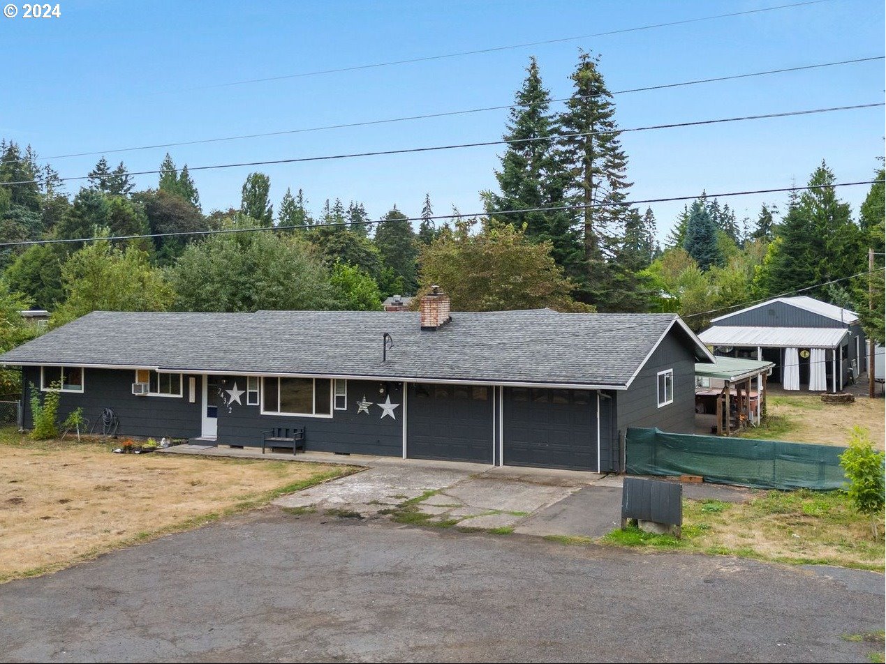 a view of a house with a swimming pool and a yard