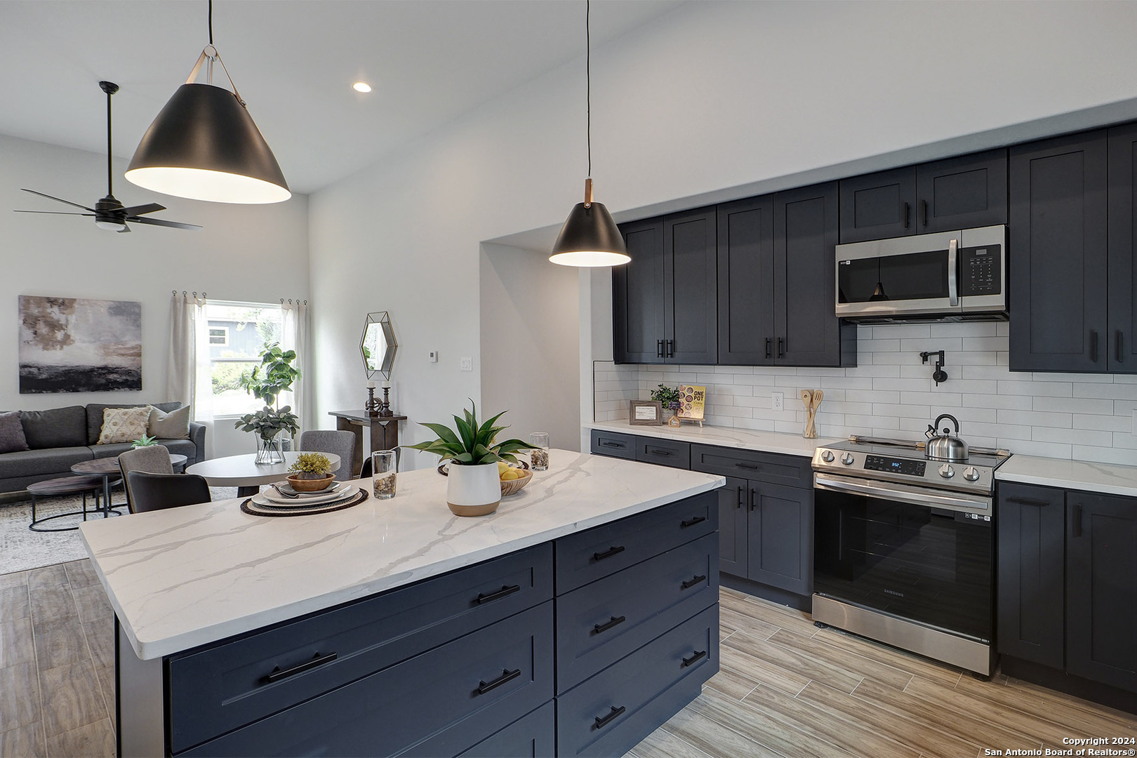 a kitchen with sink a microwave and cabinets