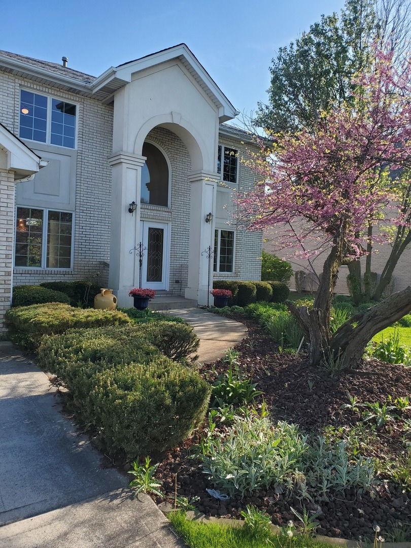 a front view of a house with garden