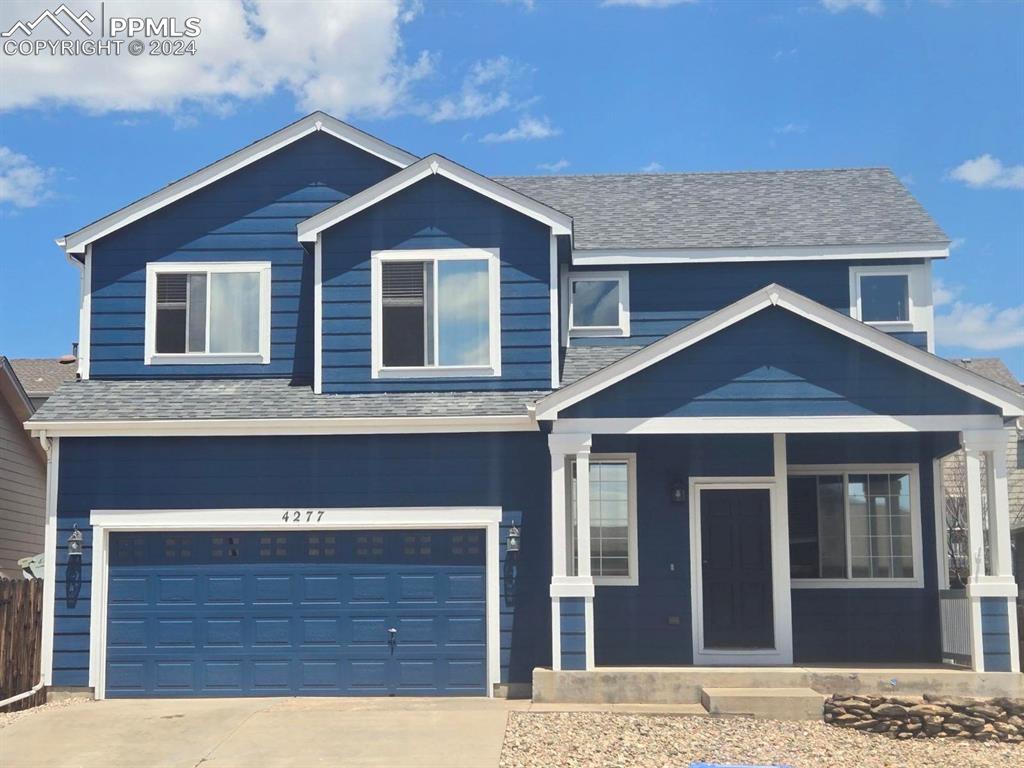 a front view of a house with garage