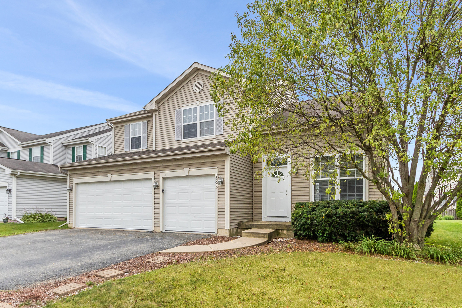 a front view of a house with a yard and garage