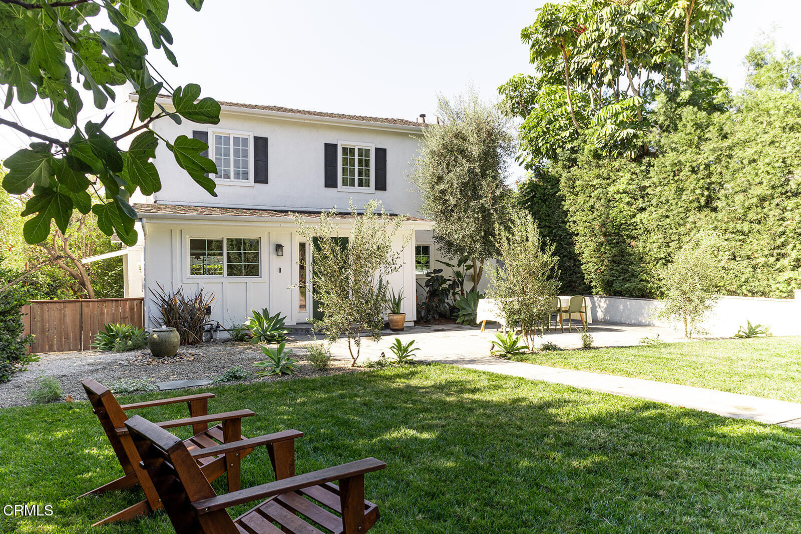 a backyard of a house with table and chairs