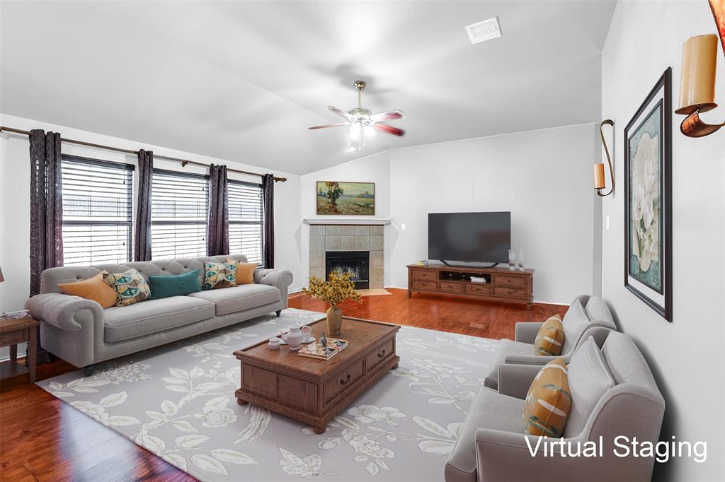 a living room with furniture a flat screen tv and a fireplace