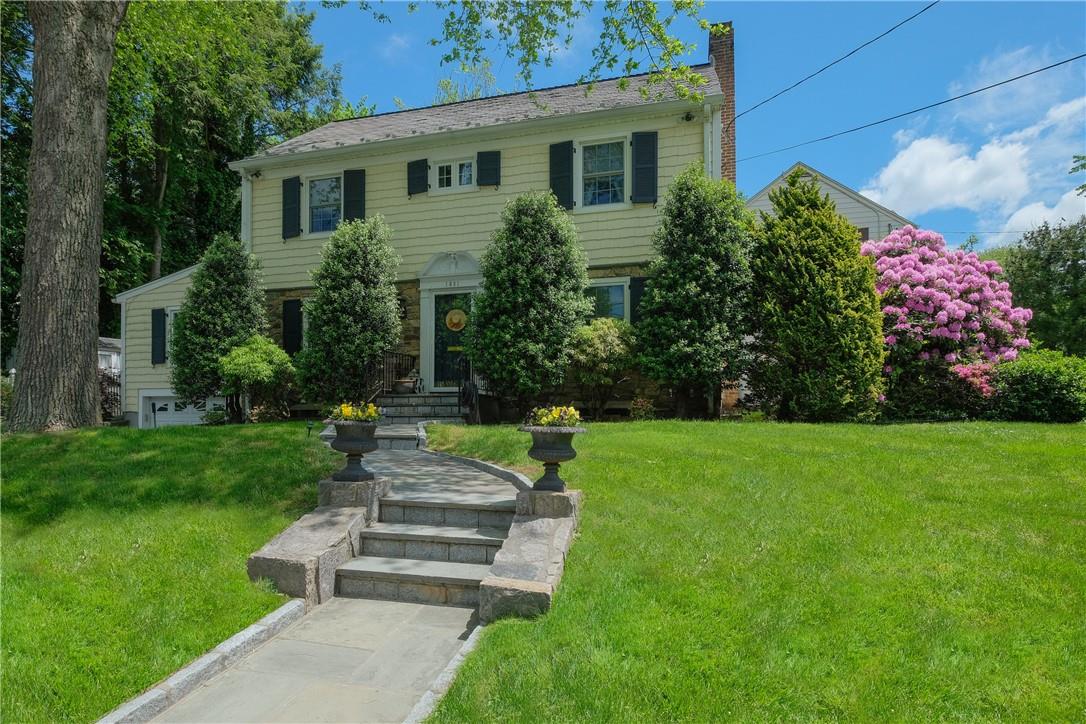 a front view of a house with garden