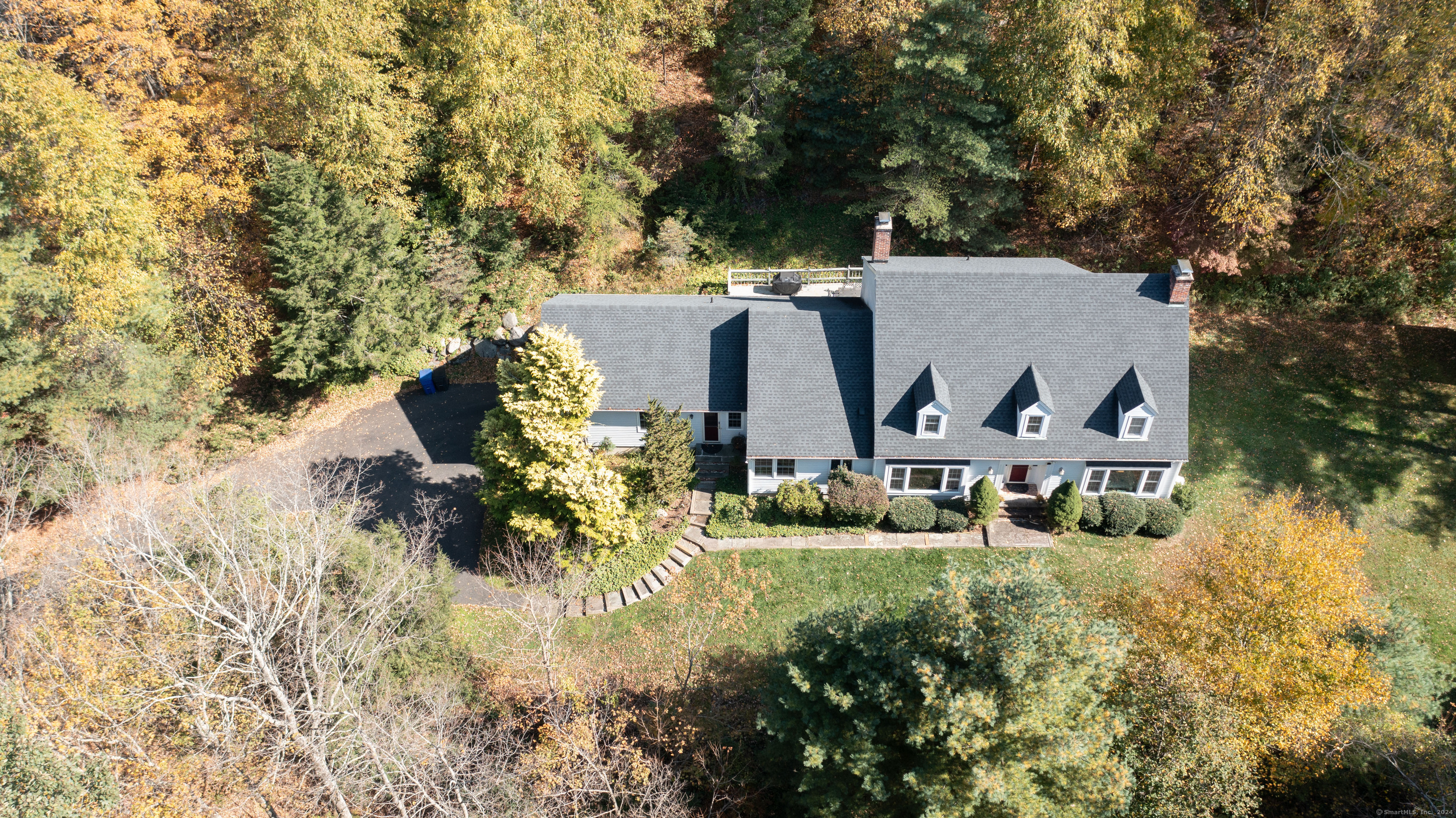 an aerial view of a house with garden space and sitting area