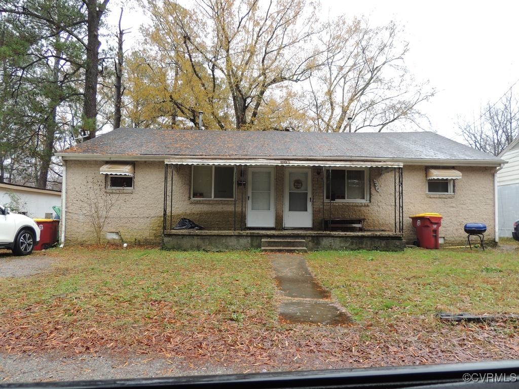 Single story home featuring a porch and a front la