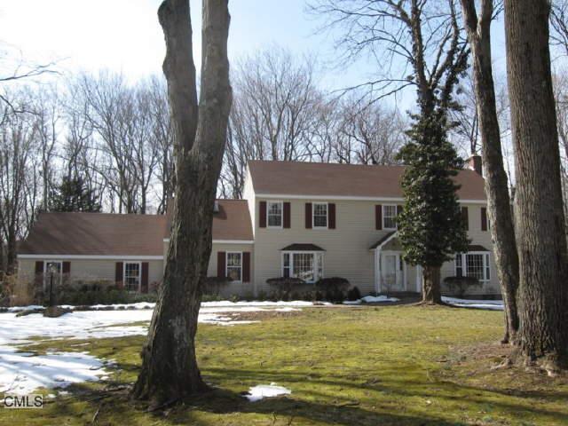 a front view of house with yard and swimming pool