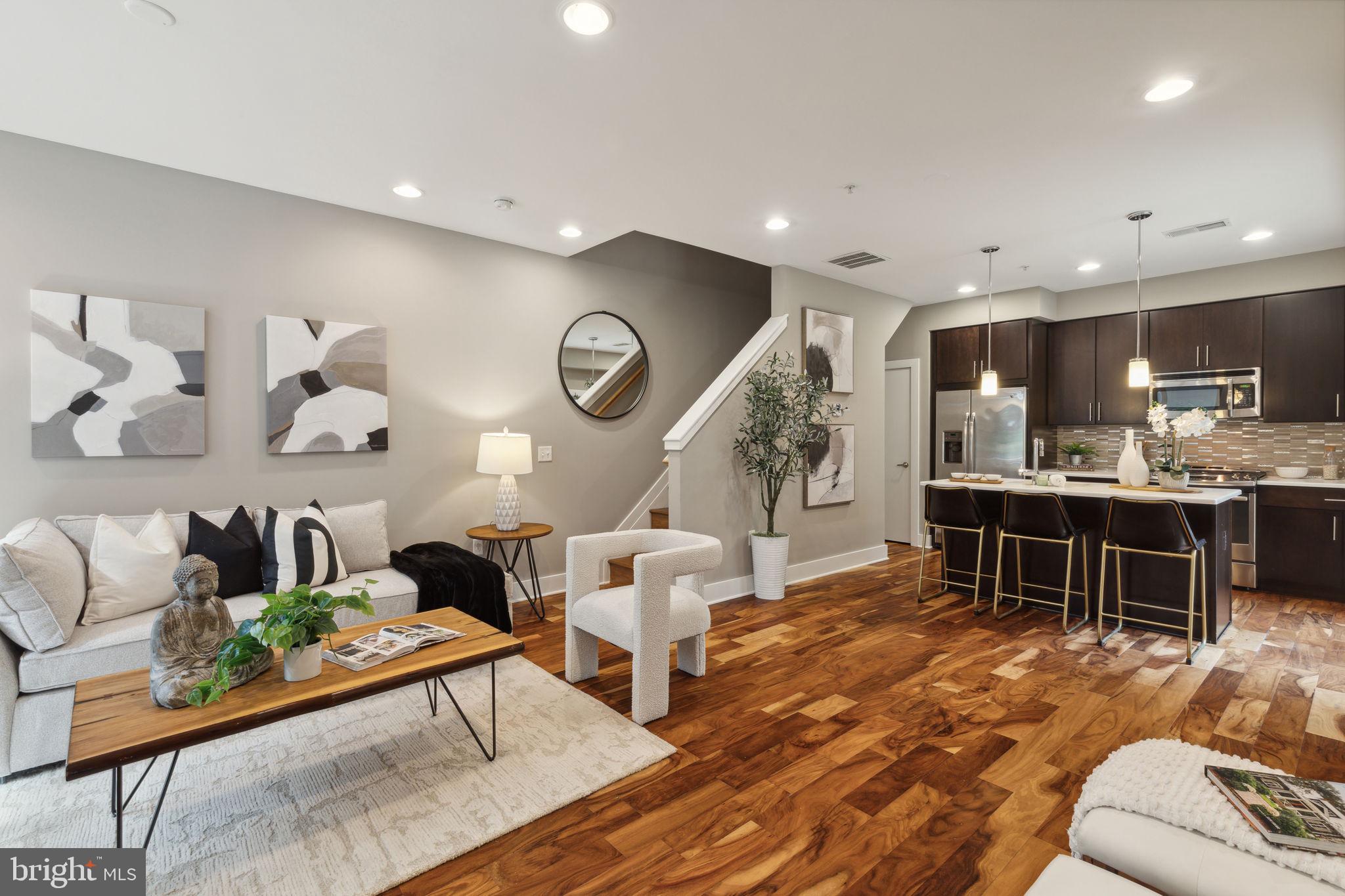 a living room with furniture and kitchen view